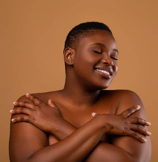 Black woman hugging herself