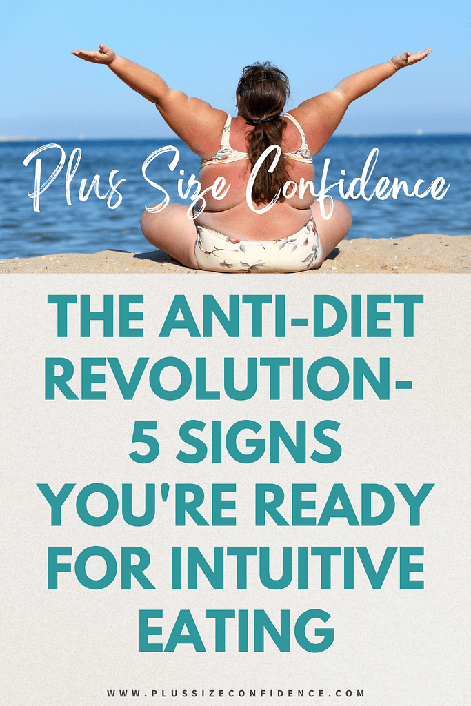 plus size woman in bikini sitting on beach with arms raised with text that says the anti-diet revolution - 5 signs you're ready for intuitive eating